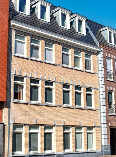 Moderne nieuwbouwwoning in Alphen aan den Rijn – Strakke, witte gevel met grote ramen en een ruime voortuin in een rustige woonwijk.